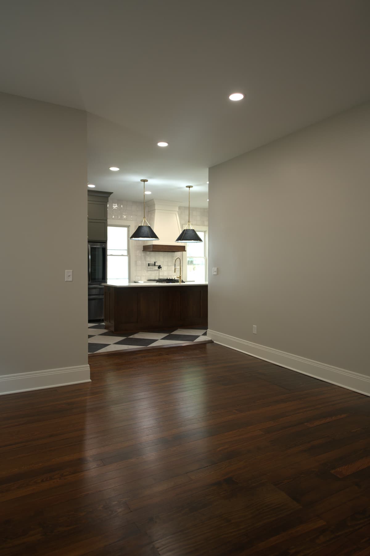 Hallway with hardwood floors and open door