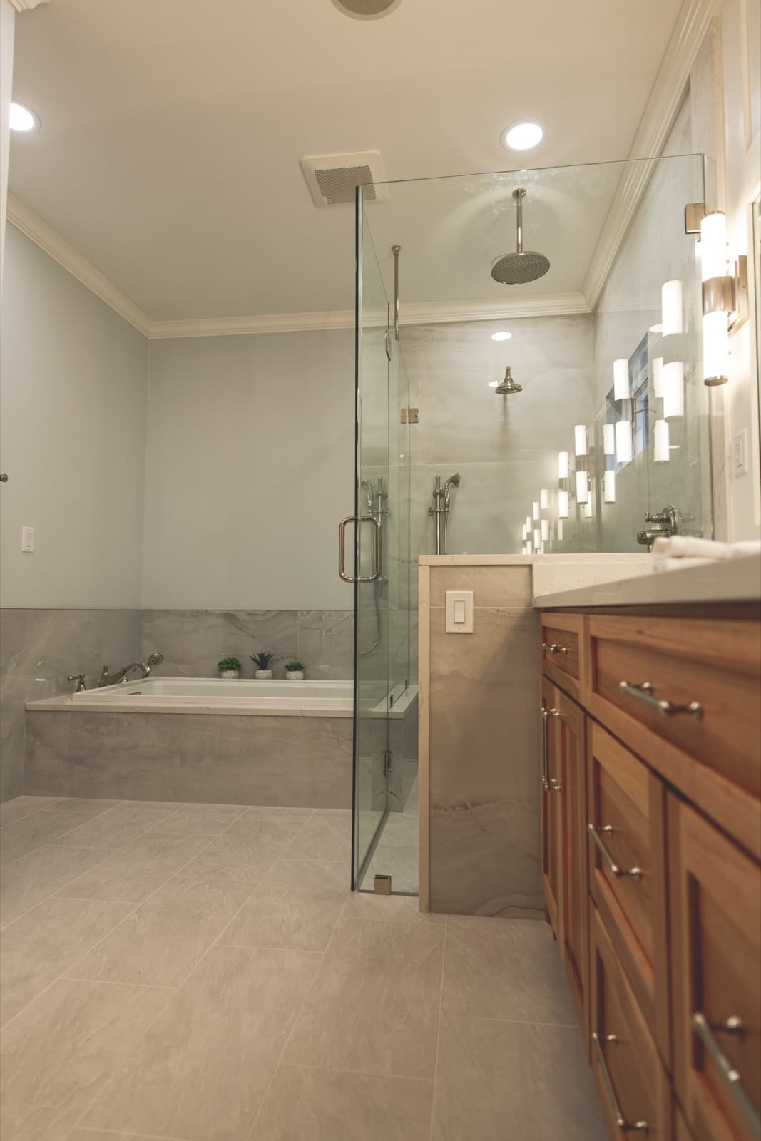 Bathroom corner detail with tub filler and large-format tile